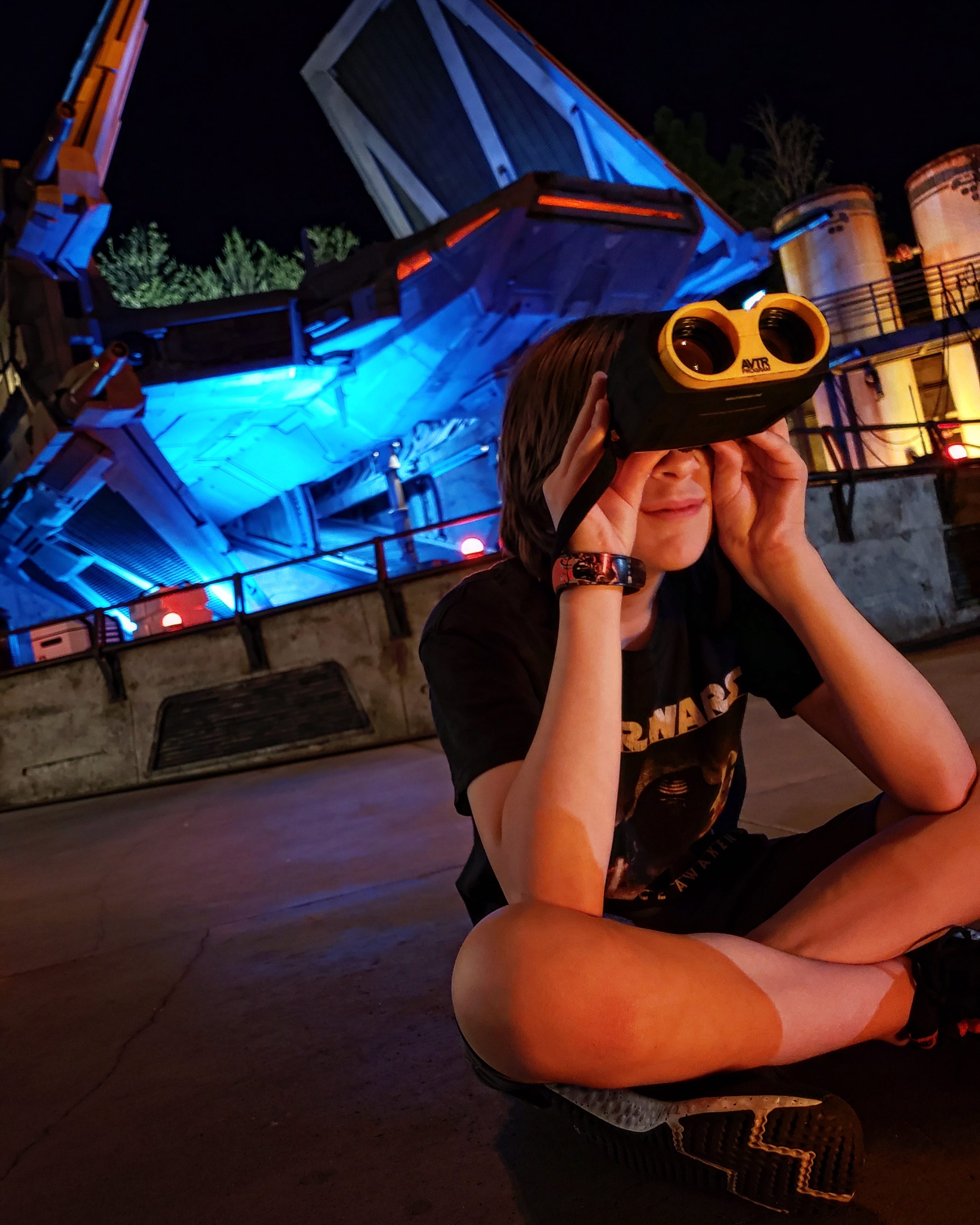 woman sitting in Star Wars: Galaxy's Edge in Disney's Hollywood Studios with binoculars